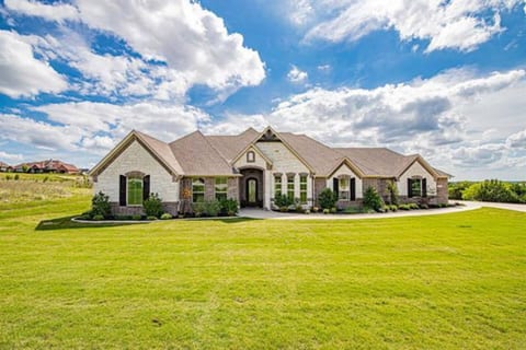 Front of Luxe home that sits on over an acre in a gated community