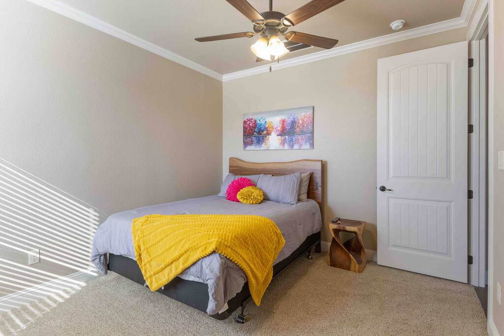 This queen bedroom offers a blend of comfort and serenity, with a view of the pool for a tranquil awakening. - Luxe Retreat: Pool, Hot Tub, Jacuzzi, EV Charger - Granbury