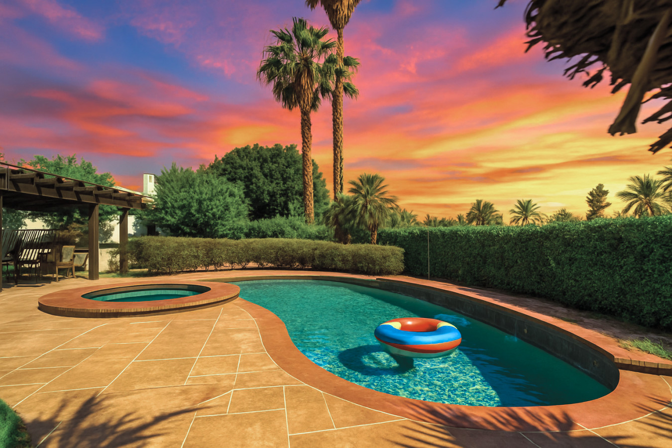 Sunset swims feel extra special in this curvy pool framed by palms, warm desert skies & glowing evening light.