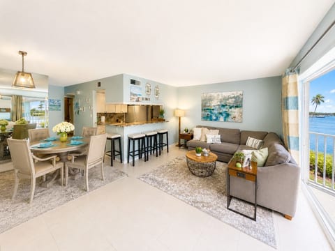 Stunning waterfront views from the bright, open-concept living room, dining area, and fully equipped kitchen. The perfect space to relax, gather, and make unforgettable memories by the water.