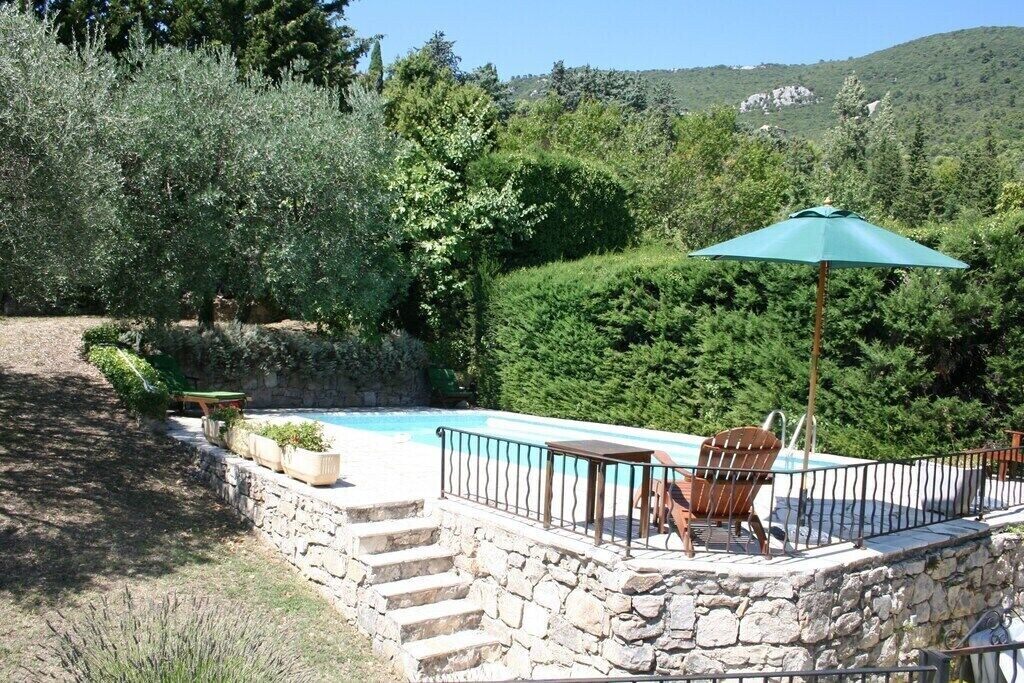 Pool, terrace and partial view of garden.