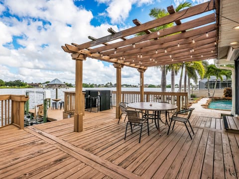 Outside dining area by the pool overlooking the water