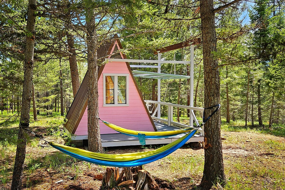 Two hammocks behind your cabin for those looking to disconnect and unplug among the pines. 