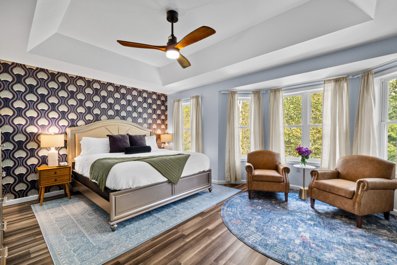 Spacious primary bedroom on the second floor, featuring a cozy window seat perfect for relaxing with a book—and a ceiling fan to keep you cool and comfortable all night.