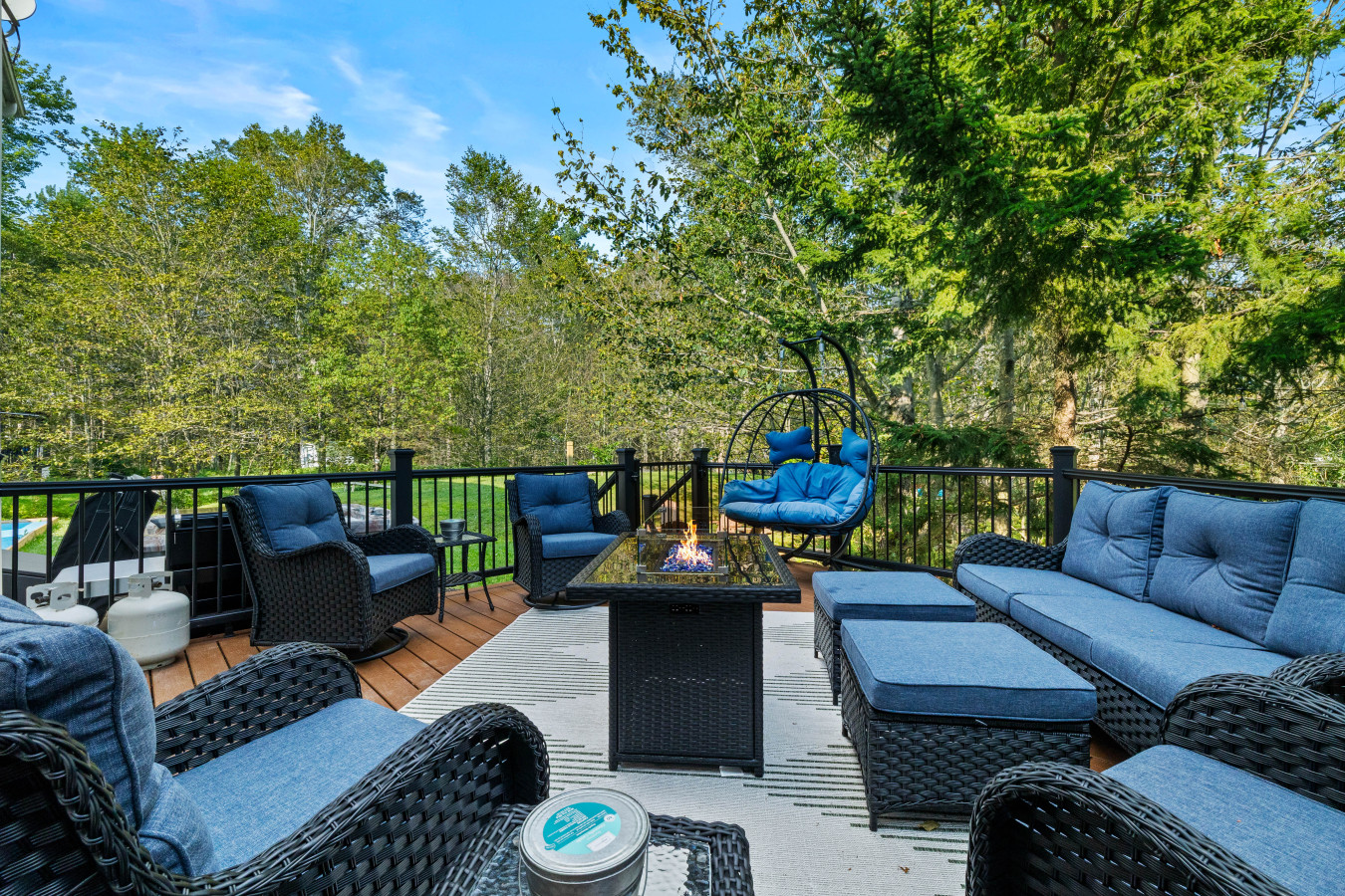 Gather around the fire pit table and settle into the many chairs on the back deck—perfect for soaking in the natural breeze and unwinding outdoors.