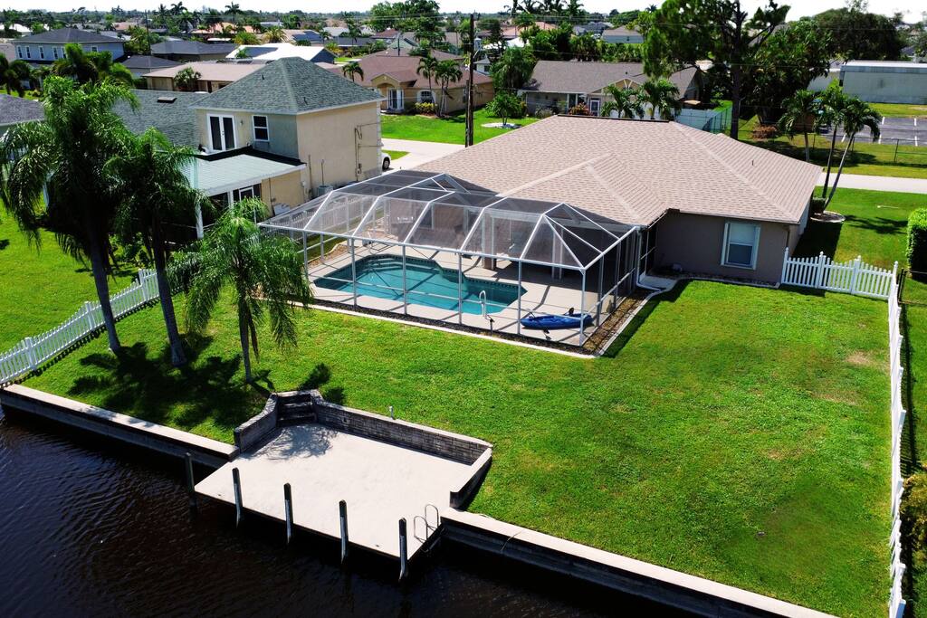 A overhead view of the fenced in backyard with plenty of room of activities. Your own personal dock for fishing and kayaking.