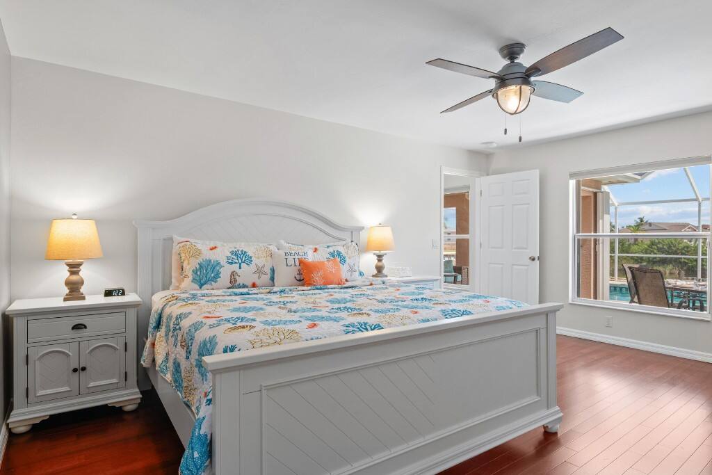 The primary bedroom is located in the back of the house, offering a gorgeous pool and waterfront canal view.