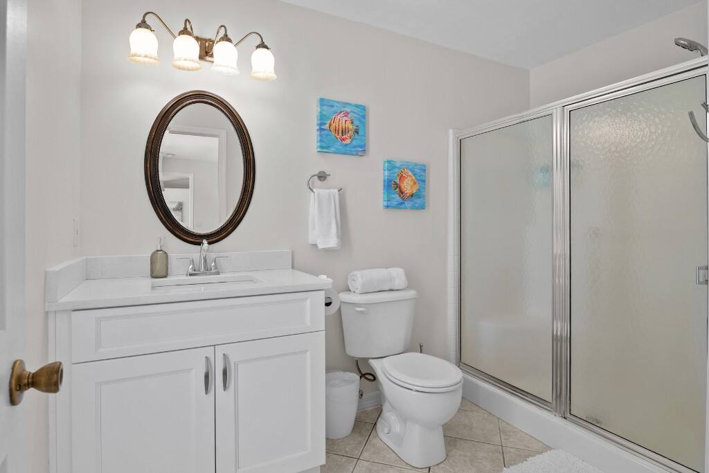 The en-suite master bathroom is a private space with a large walk-in shower. Shampoo, conditioner, body soap, and hand soap are provided, along with towels.