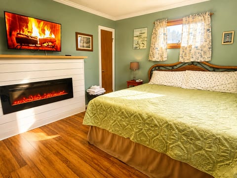 New fireplace brings serenity and warmth to this King Master bedroom with memory foam mattress, large dresser, closet, sound machine, alarm clock, and 40" Roku ready LED TV.