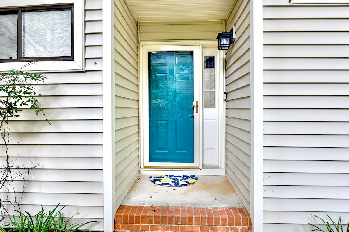 Front door entrance (accessed from right side of home) with smart lock on door.