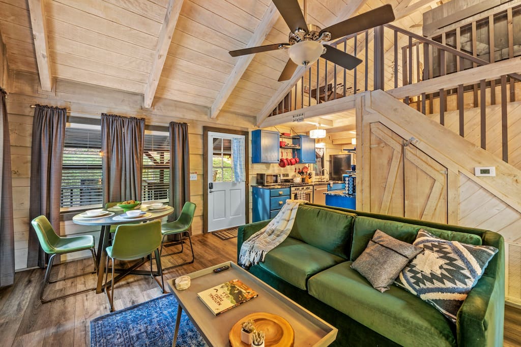 Living room. The green sofa pulls out to be a bed. The laundry is in the closet behind the sofa. 