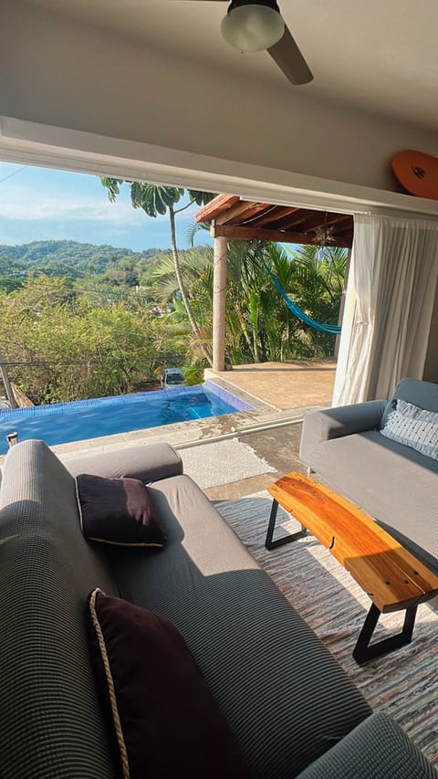 Living room with sliding doors to the pool and outdoor hammock area