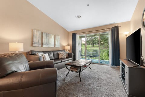 Vaulted ceilings, roomy seating, and deck access make the living room an easy place to settle in after a day in Branson.