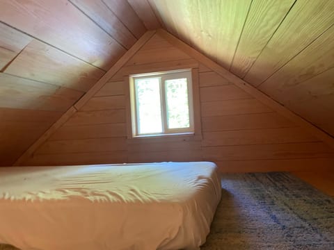 Single loft bed on carpet. Bedding will be provided (not shown)