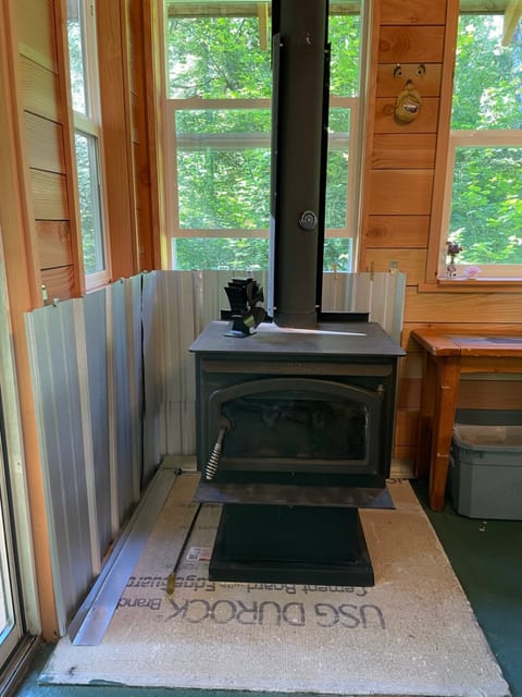 Functional wood stove comes with wood, kindling, fire starter and a lighter. Notice the funny guy on the wall holding the matches!
