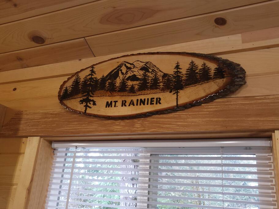 Handmade custom sign hangs over kitchen window.