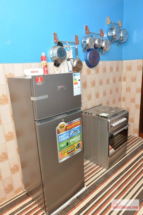 Kitchen with various spices and equipments: microwave, dishwasher, kettle, rice cooker, fufumix, refrigerator, gas cooktop, with oven. - The 6 Roses Full 2nd Floor, Safe, King Beds, Wi-Fi - Porto-Novo