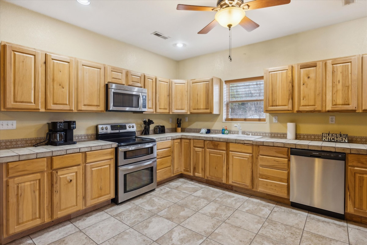 Kitchen Delight: Spacious kitchen with wood accents, modern appliances, and natural light to inspire meals!