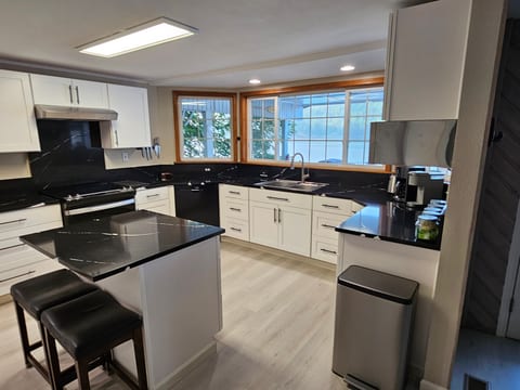 Fully equipped kitchen next to the dining room overlooking the deck and lake.