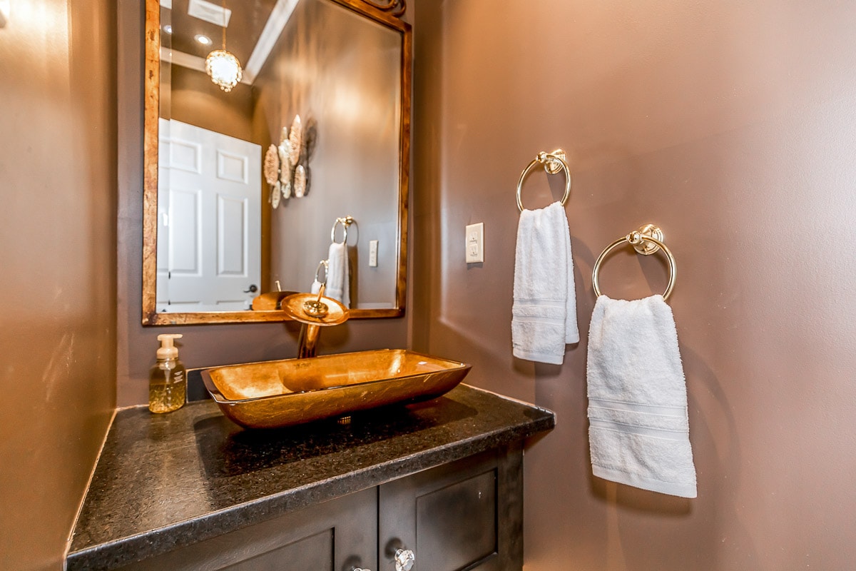 A restroom is located on the main floor, conveniently accessible from the living room, pool room, and the side door off the lobby.
