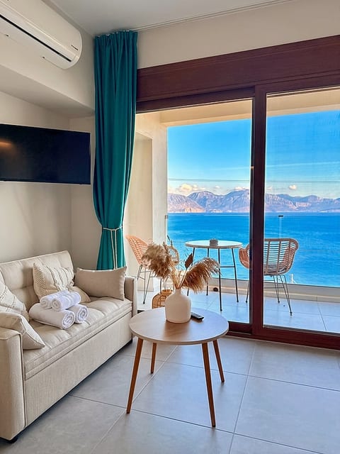 Seafront lounge with balcony, panoramic sea & mountain views