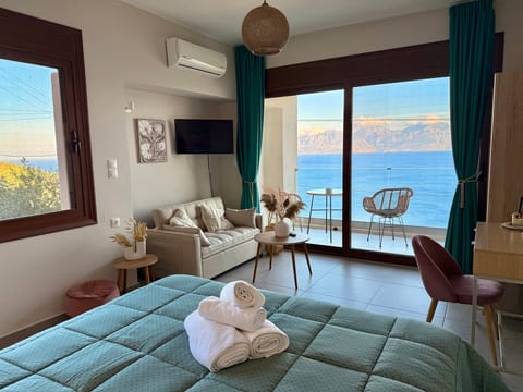 Chic seaside studio with balcony, cozy lounge, and stunning ocean views