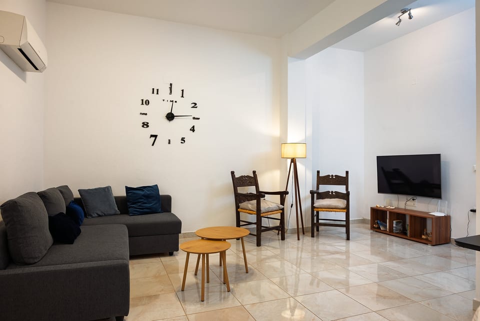 Bright, spacious living room with sectional sofa, TV, and cozy seating
