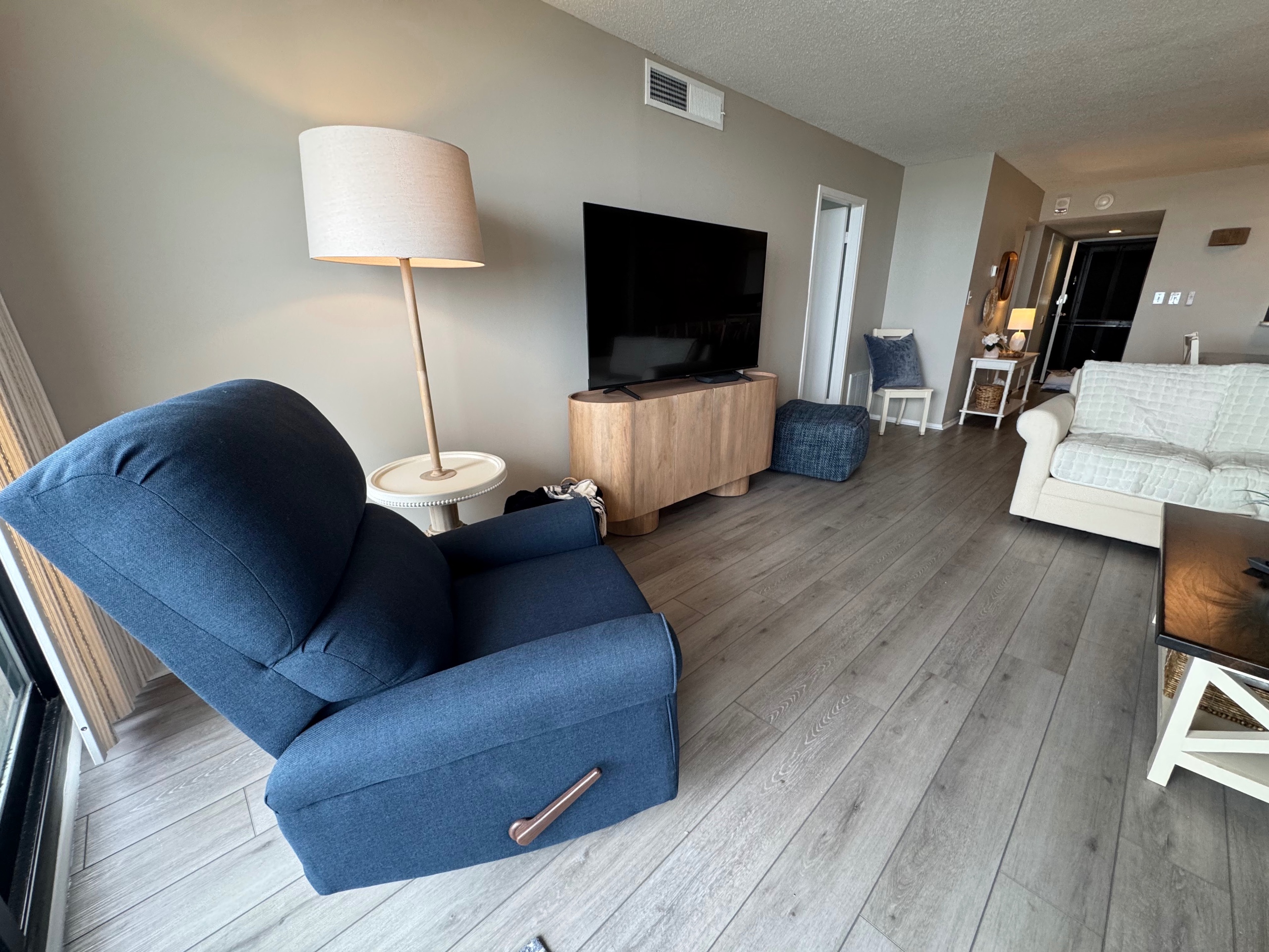 Living room with view to front door. Serving Sand East
