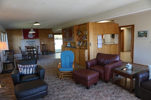 Living room Seating area with dining table & fireplace beyound