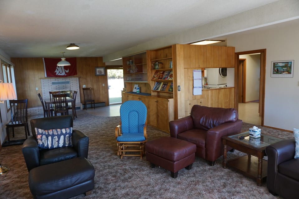 Living room Seating area with dining table & fireplace beyound