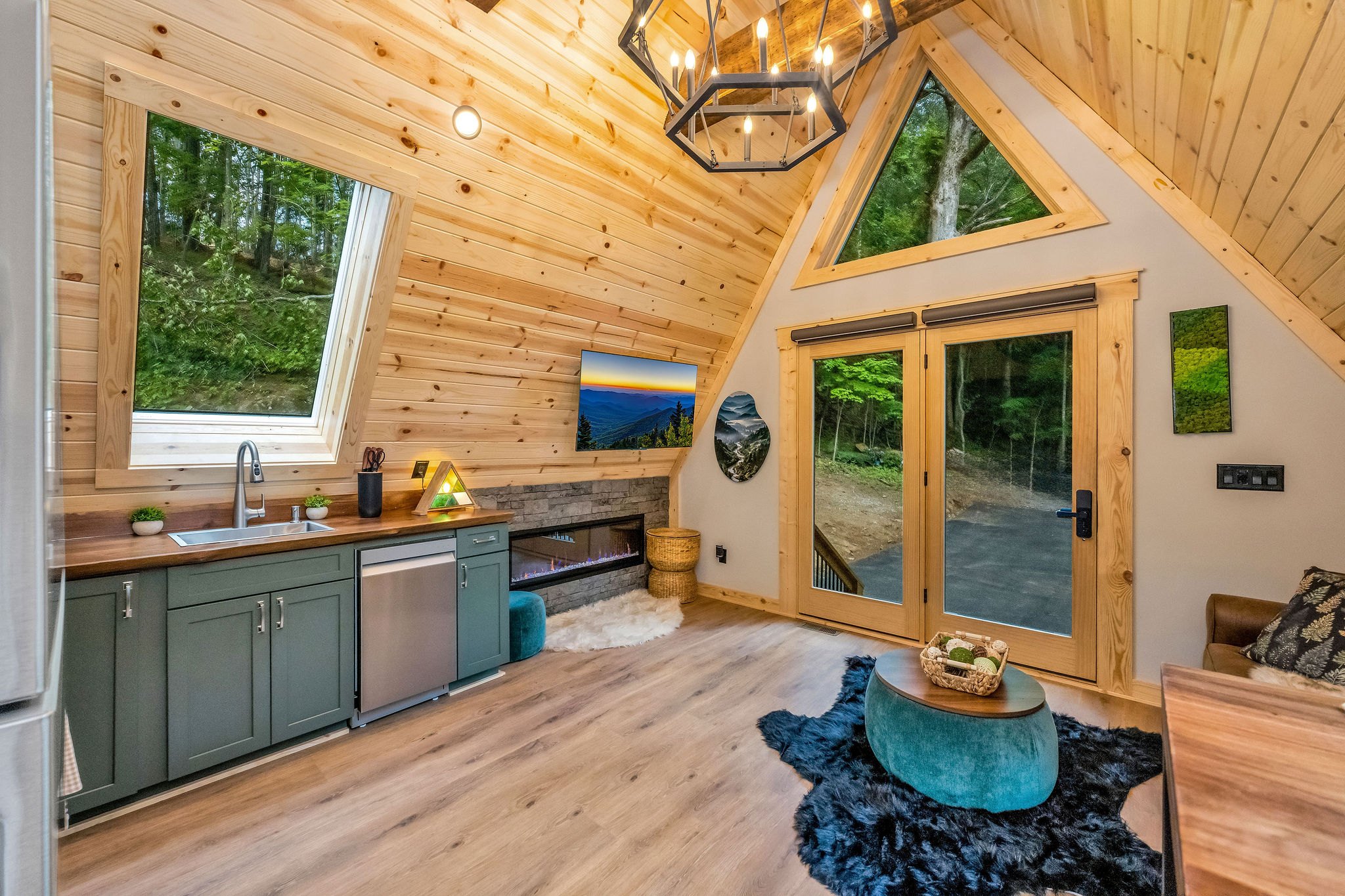 Living Area View with Fireplace and TV leading to front door Living Area View with Fireplace and TV leading to front door - High Peak Aframe Cabin - West Jefferson