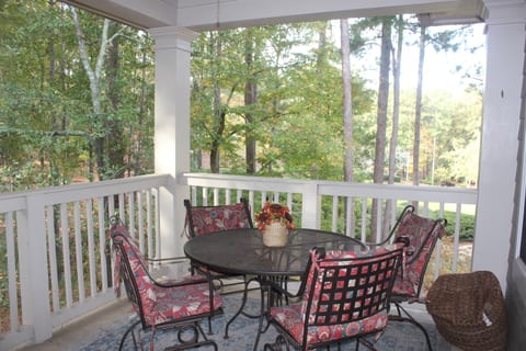 Outdoor balcony with table and rockers; overlooks the golf course and woods. Very private!