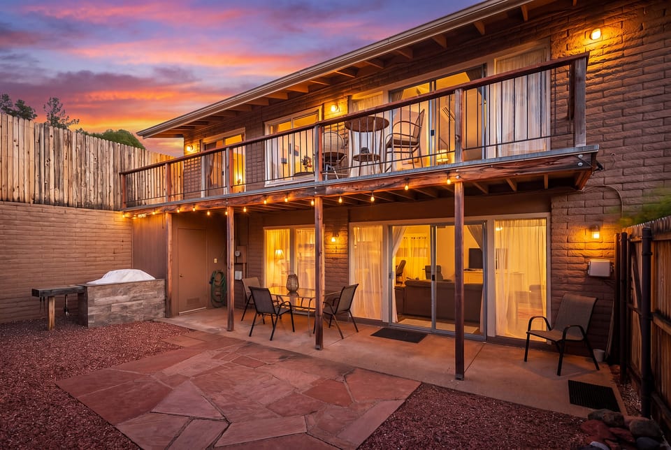 Private fenced patio with string lights, BBQ, and dining for six — pet-friendly Sedona evenings under the desert sky.