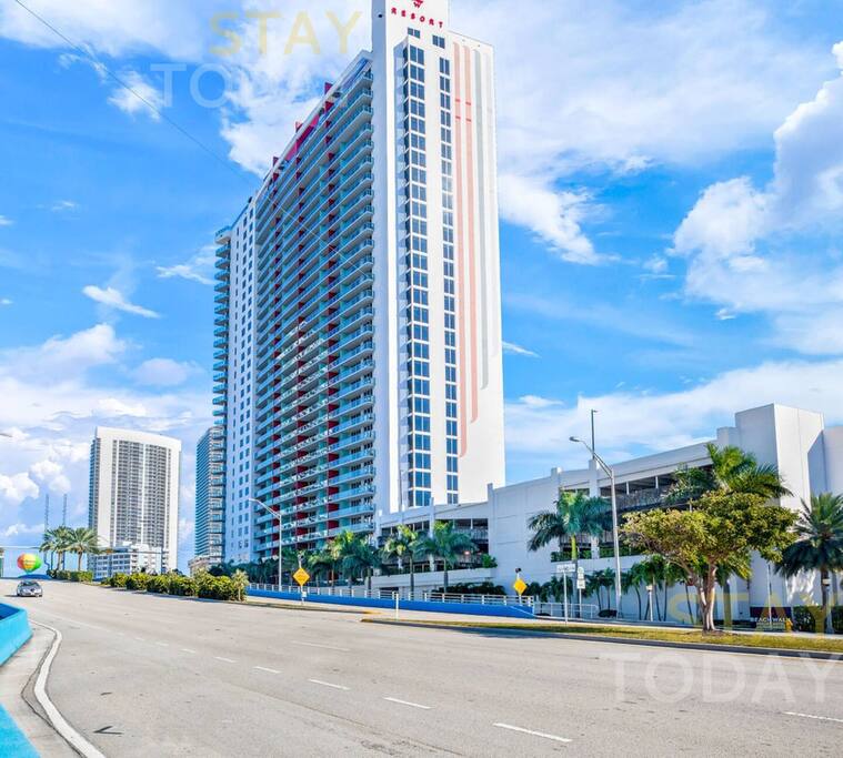 A stunning full view of the entire building, showcasing its impressive height, modern architecture, and sleek design. A true statement of style and sophistication!