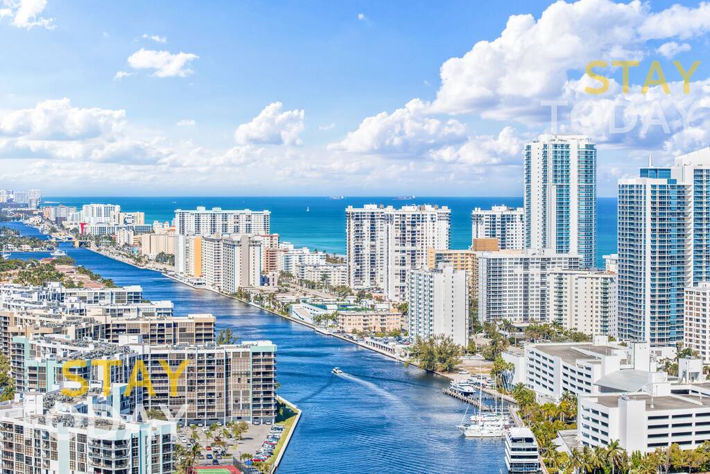 This stunning view showcases the Intracoastal Waterway with towering high-rises in the distance. A perfect blend of water and cityscape, this breathtaking vantage point captures the beauty of modern architecture against a serene waterfront backdrop.