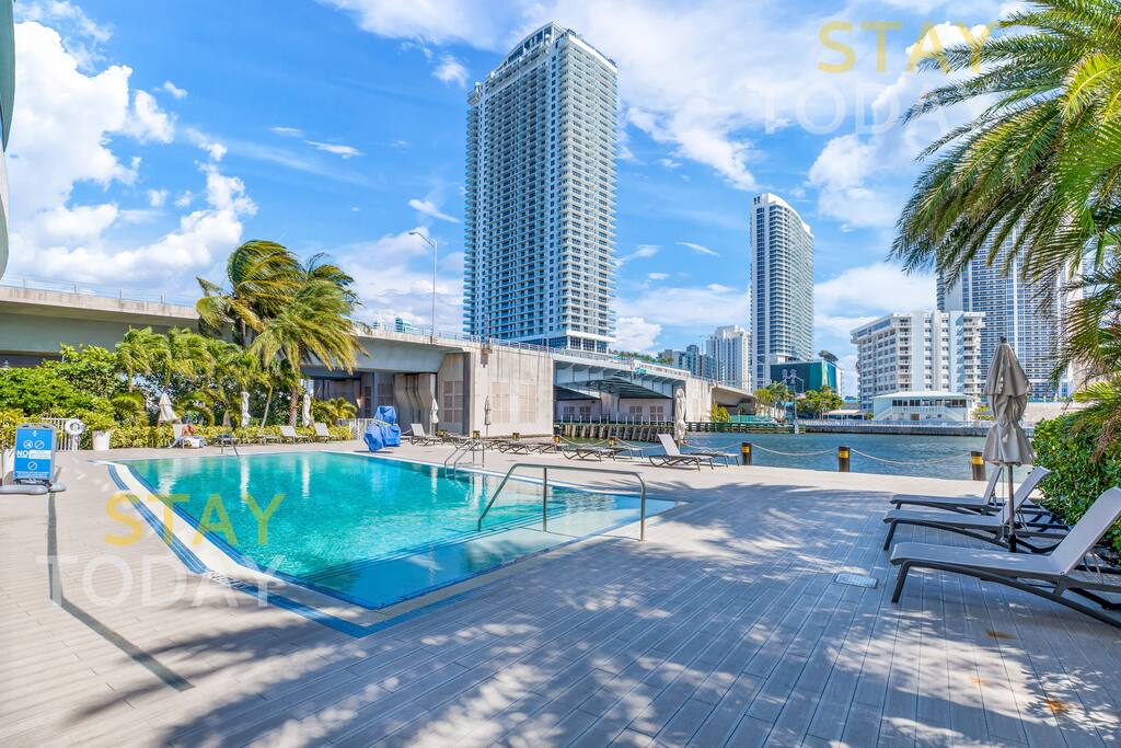 Another view of the pool, featuring the shaded area created by the surrounding trees. This cool and tranquil spot offers the perfect place to relax and enjoy the outdoors without the direct sun.