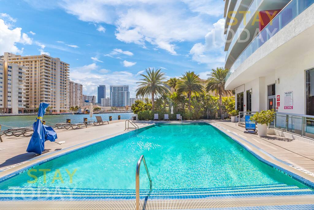 Another view of the pool, highlighting its impressive length. The expansive design offers plenty of space to swim, relax, and enjoy the water, making it a perfect spot for leisure and fun.