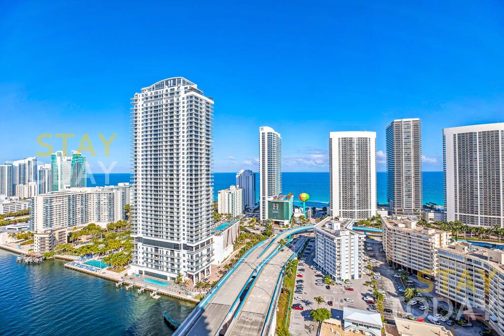 Stunning bird’s-eye view of the surrounding area, showcasing towering buildings and a beautifully designed landscape. A breathtaking perspective that highlights the vibrant and modern cityscape.