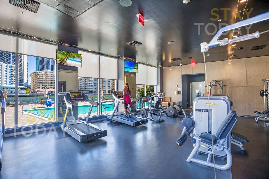 Another angle of the gym, showcasing its spacious layout and modern equipment. Whether you’re lifting weights or using cardio machines, this well-equipped area provides everything you need for a great workout.