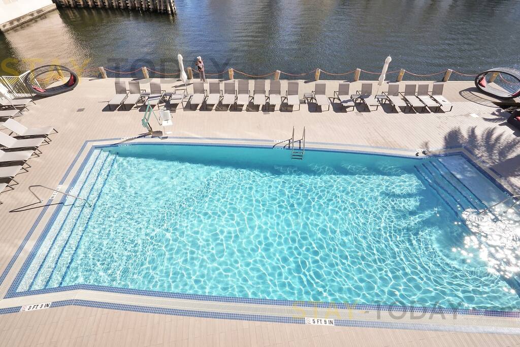 Zoomed-in bird's-eye view of the pool, perfectly located beside the Intracoastal. This picturesque setting offers a stunning backdrop, making it an ideal spot for a photo shoot or simply enjoying the scenic beauty.