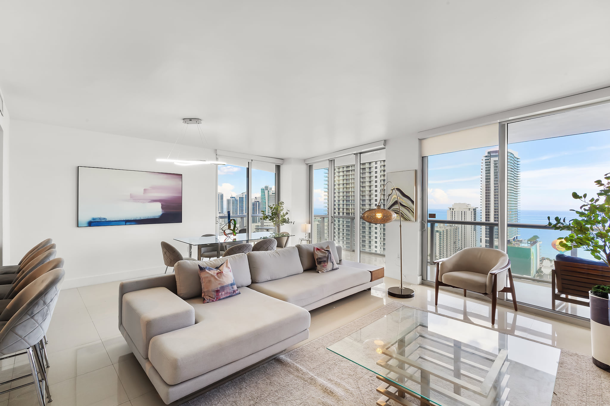 Sky-high retreat with ocean panoramas, floor-to-ceiling windows, chic decor.