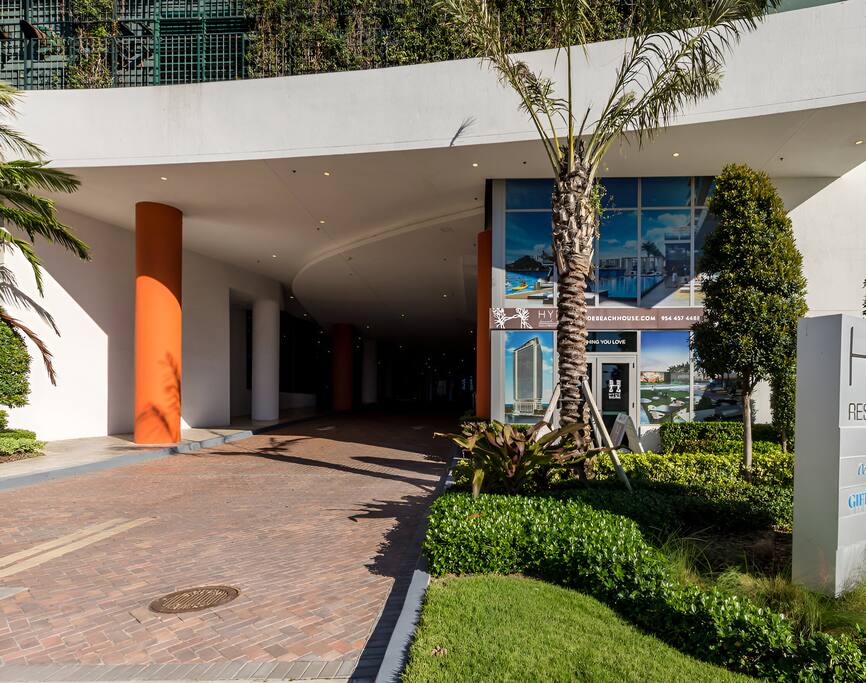 The covered driveway and entrance provide convenient and sheltered access to the building, surrounded by well-maintained landscaping and a welcoming atmosphere.