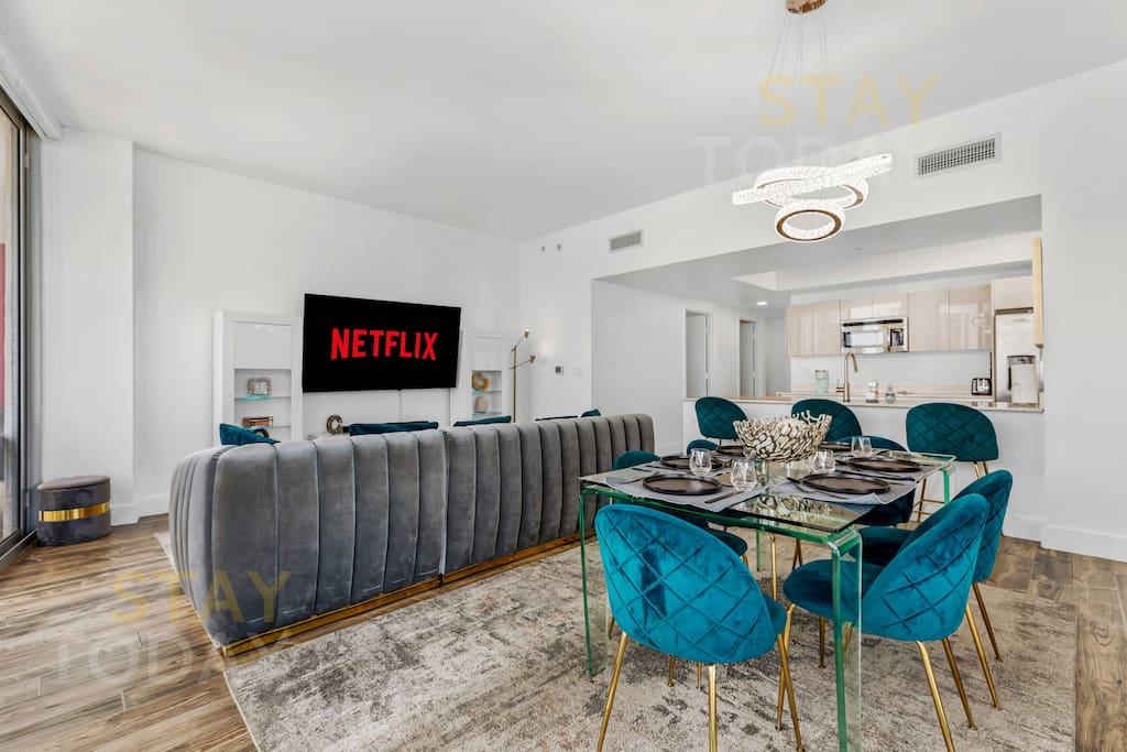 The dining area exudes elegance with its plush, soft-cushioned chairs that invite you to sink in and relax. Paired with a sleek table and a stunning backdrop, this space is perfect for enjoying meals in absolute comfort and style.