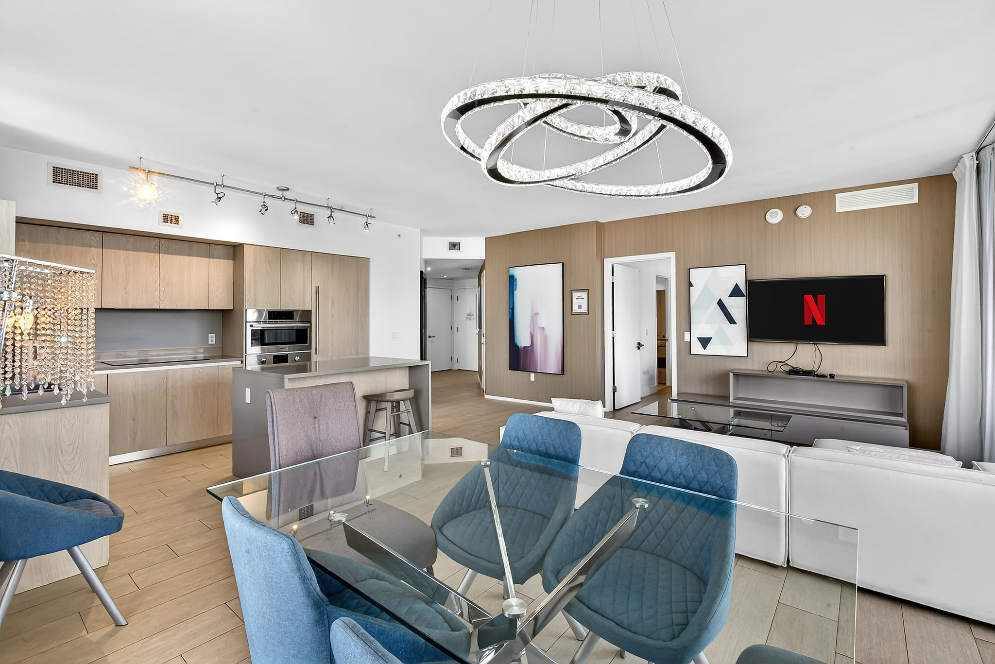 Modern open-plan condo with chic lighting, island kitchen & smart TV