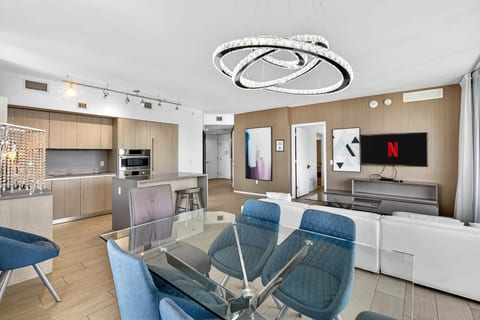 Modern open-plan condo with chic lighting, island kitchen & smart TV