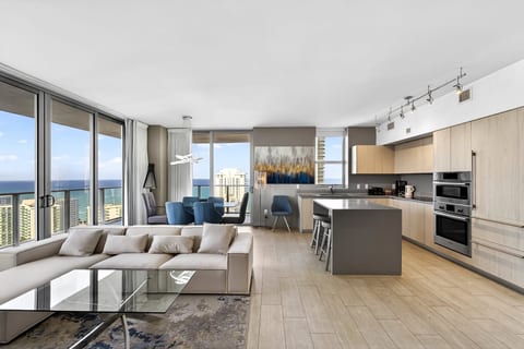 Sleek ocean-view condo with gourmet kitchen, island seating, and bright lounge.