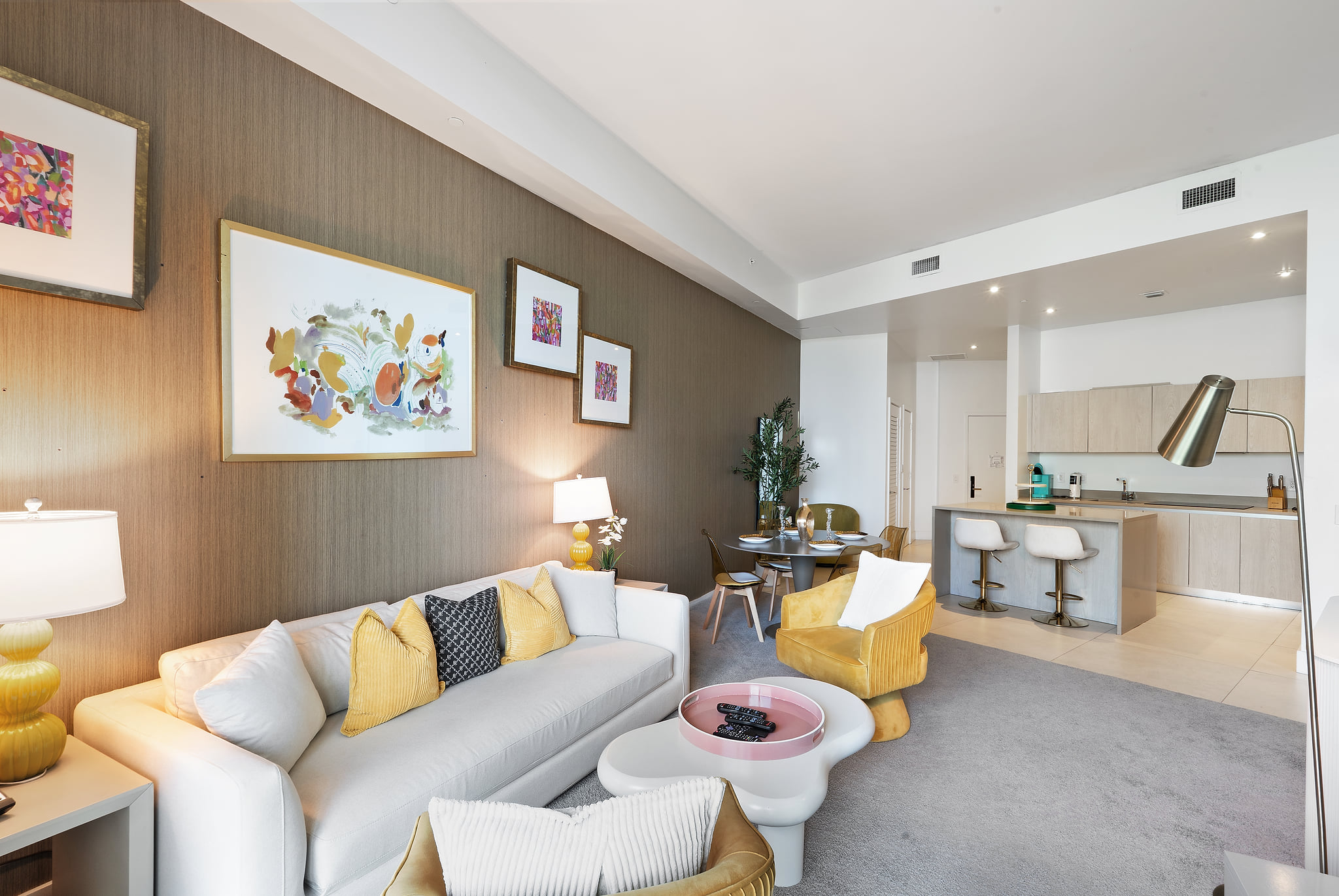 Bright open-plan living with chic decor and sleek kitchen bar.