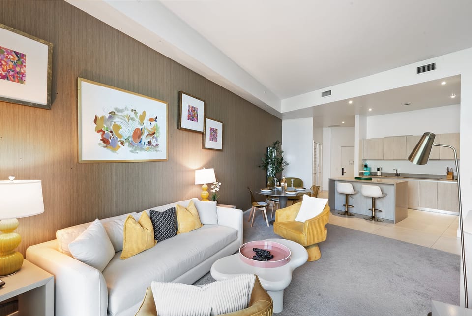 Bright open-plan living with chic decor and sleek kitchen bar.