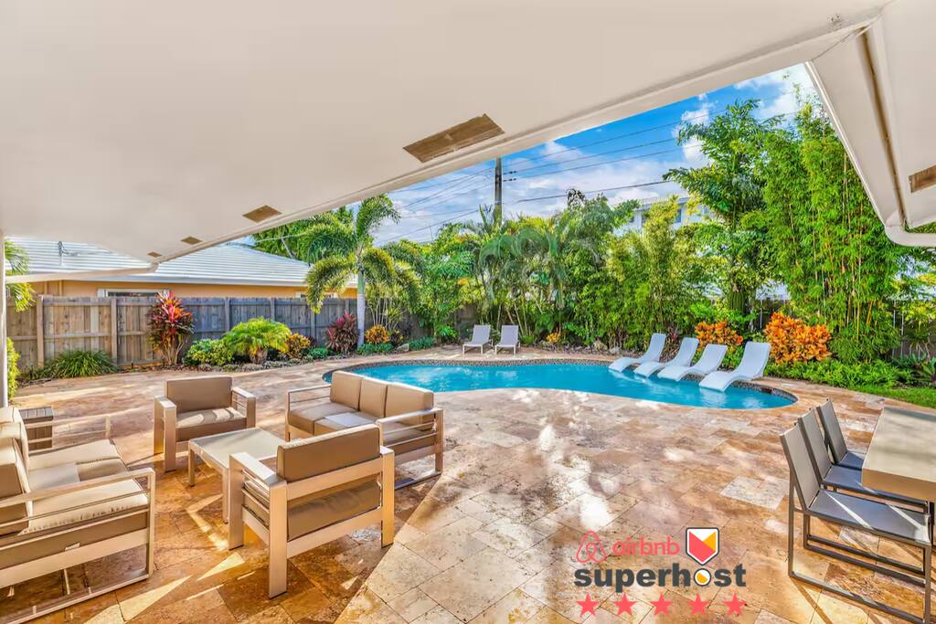 Step outside to your private tropical oasis, complete with a sparkling heated pool, comfortable lounge chairs, and shaded seating areas. Perfect for relaxing, entertaining, or simply soaking up the South Florida sun.