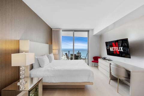 Step into Bedroom 2, a peaceful suite with a king bed, walk in closet, and private ensuite bathroom. Soft lighting and balcony access create a calm space to wake up, work comfortably, or unwind with ocean views.